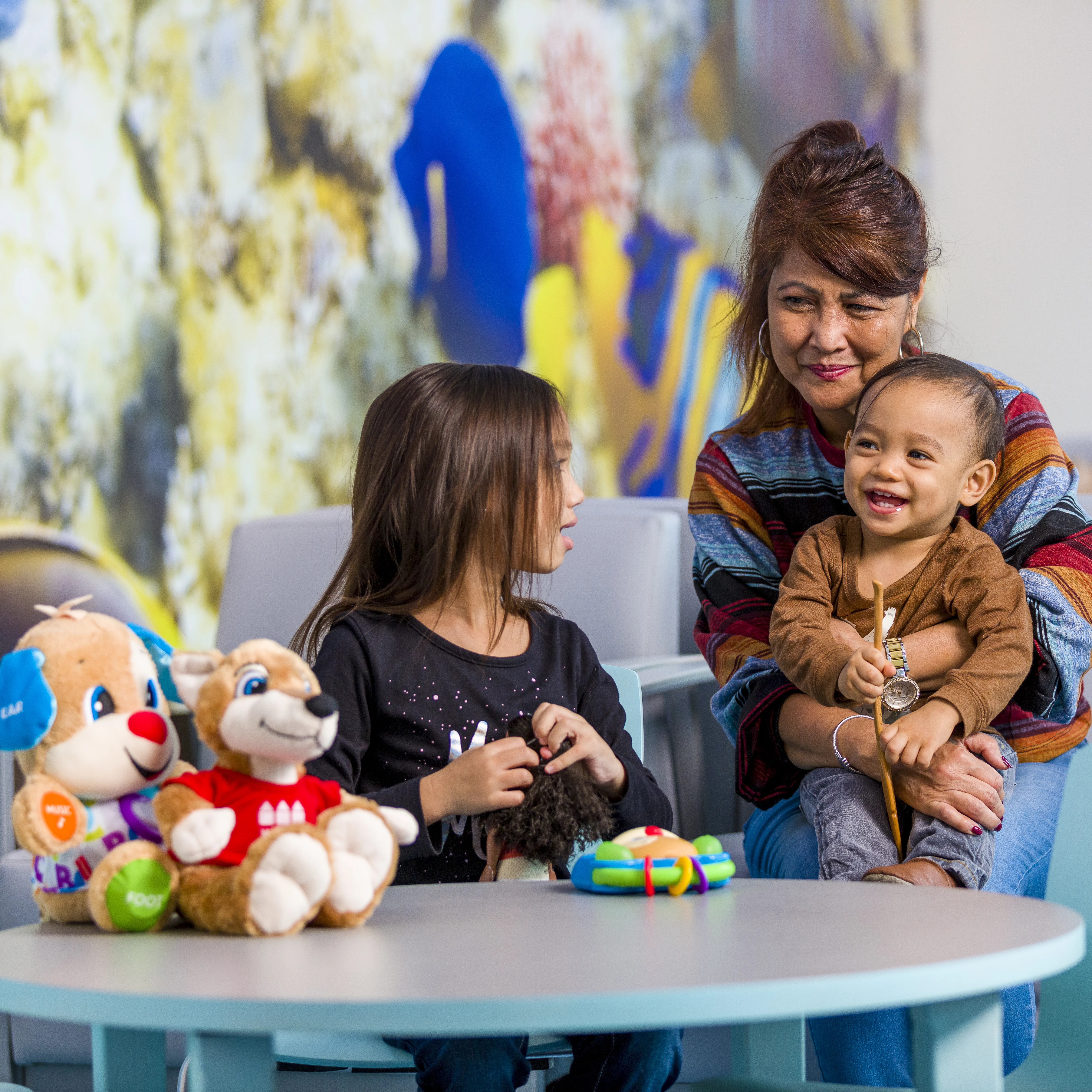 mom sitting with her two children in the waiting room of the Emergency Room at Wolfson Children's Hospital