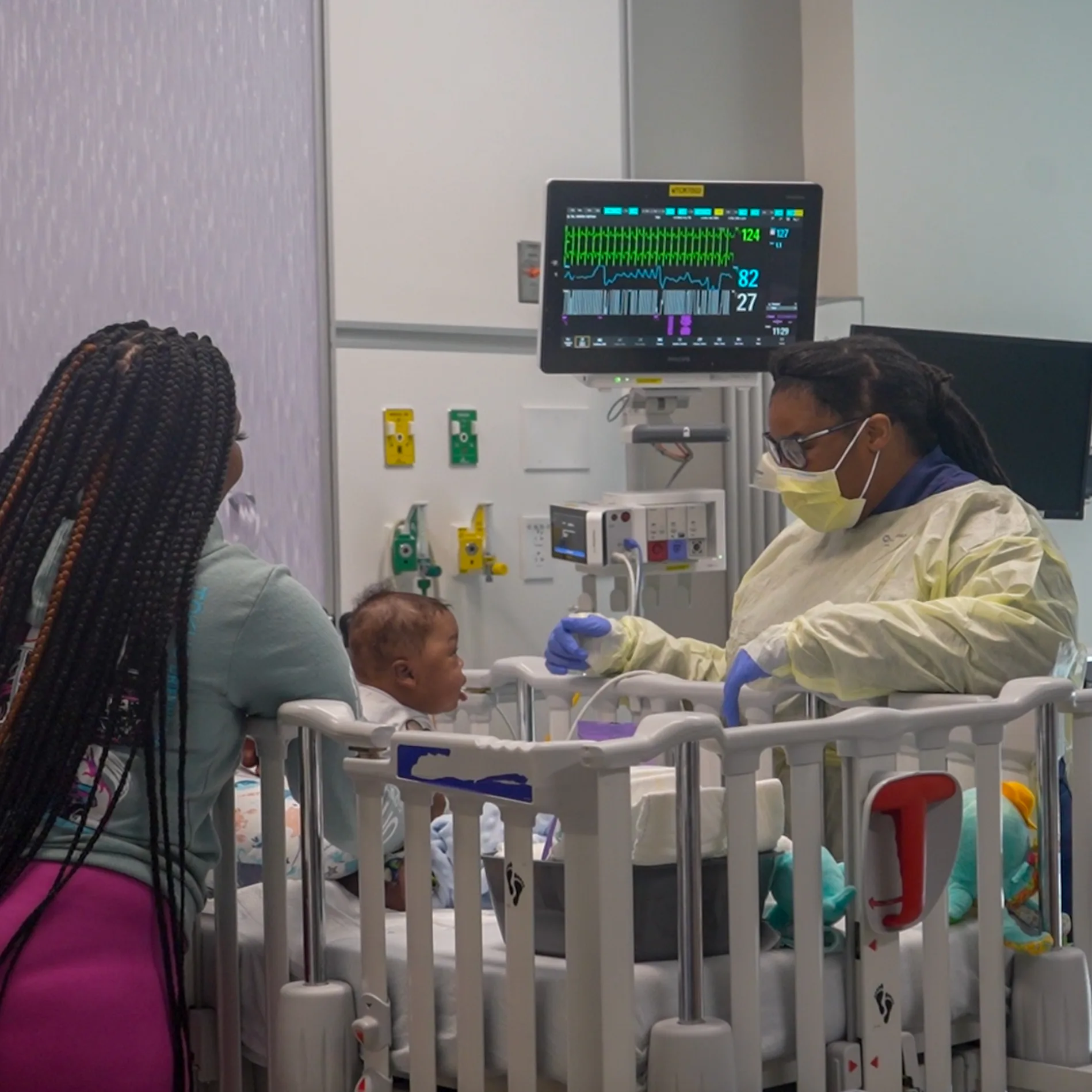 social worker spends time with mom and baby in a hospital room