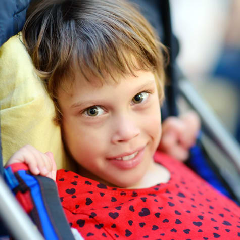 close up of smiling small child wearing a red shirt
