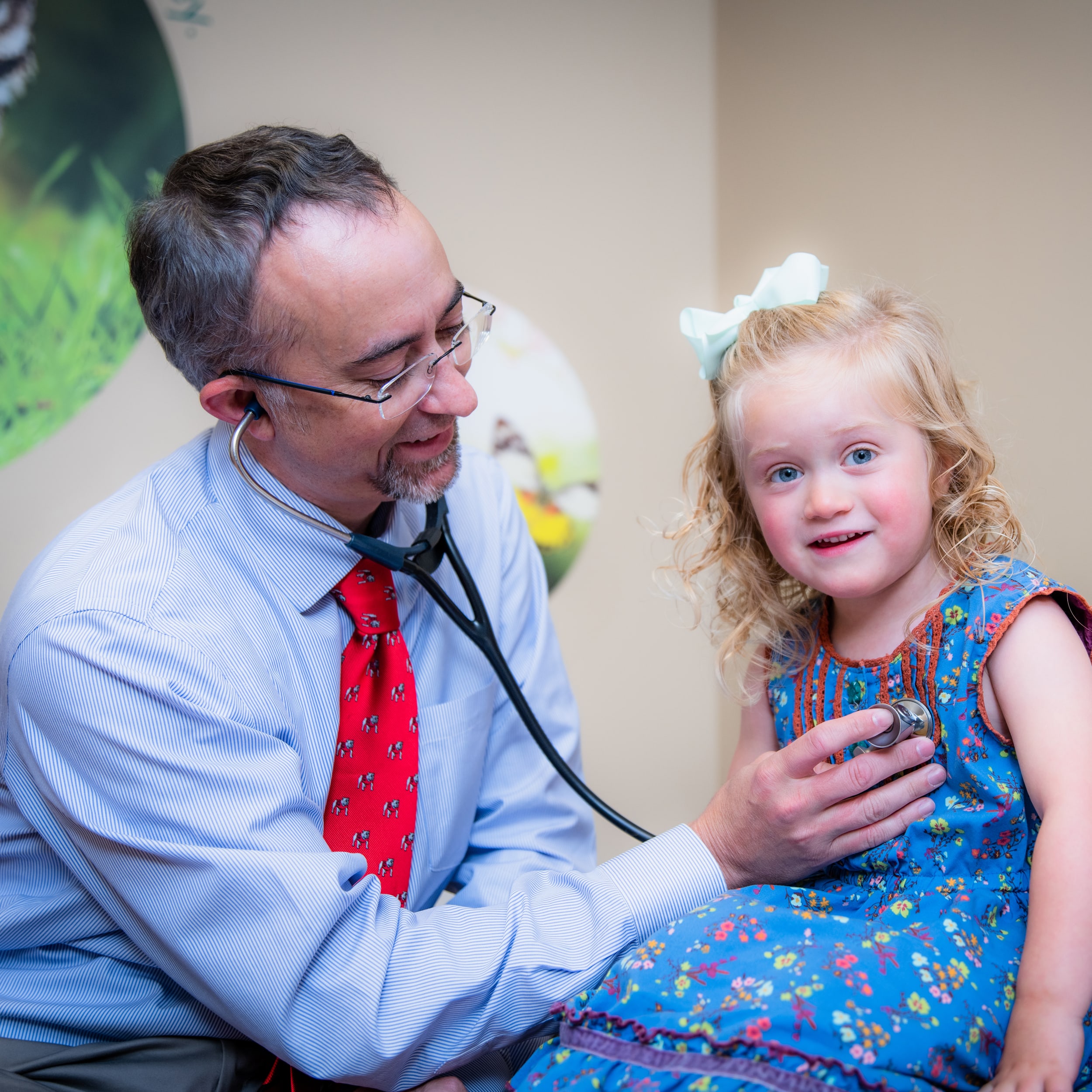 Doctor using stethoscope on child