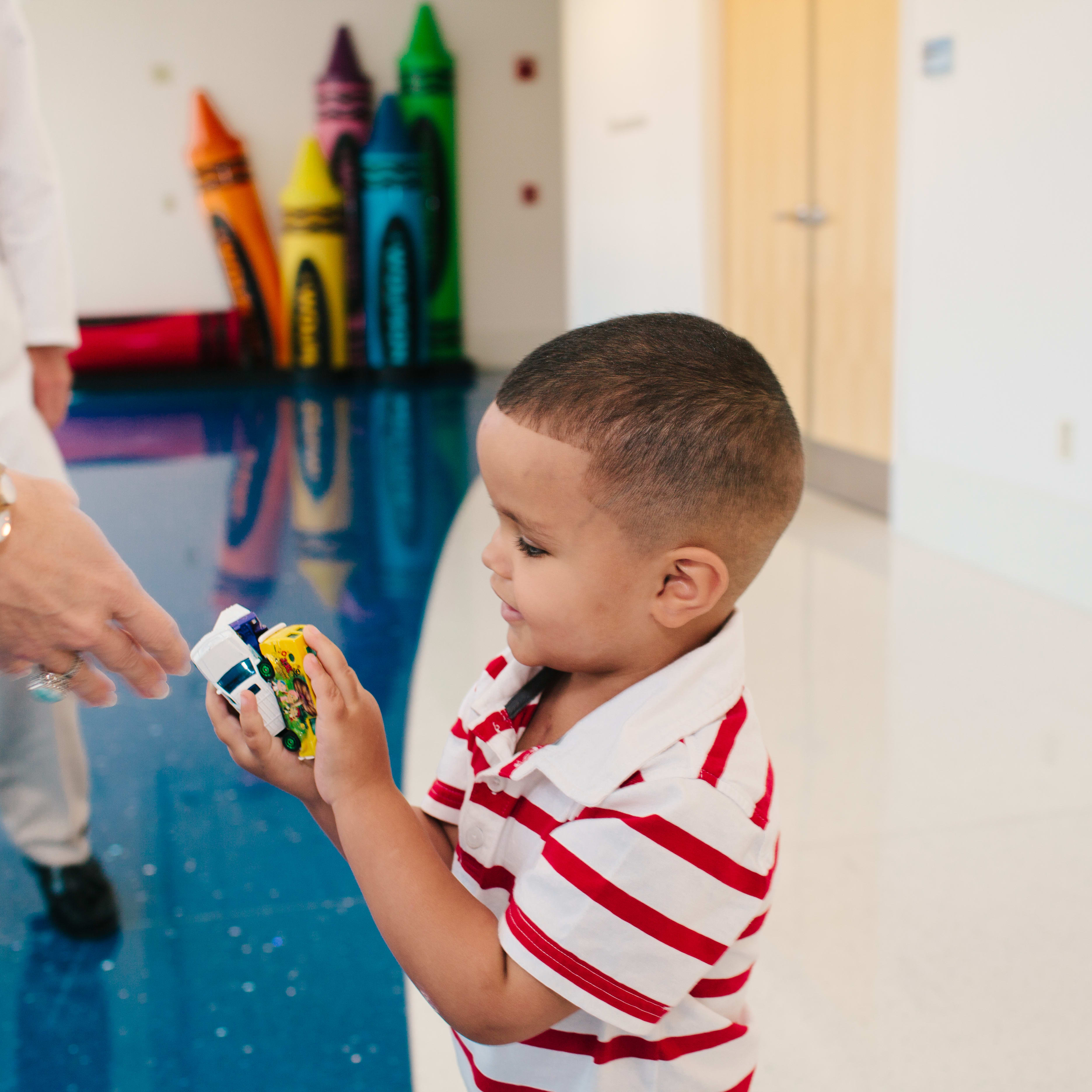 child playing with toys in a hospital setting