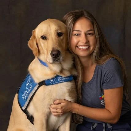 child life specialist hugging her therapy dog