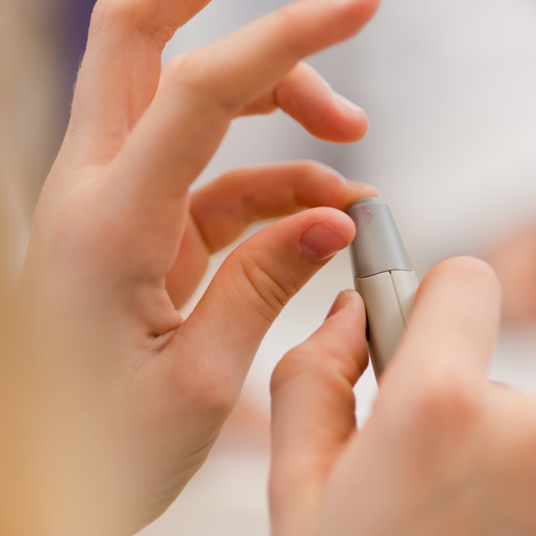 close up of a child doing a finger prick test