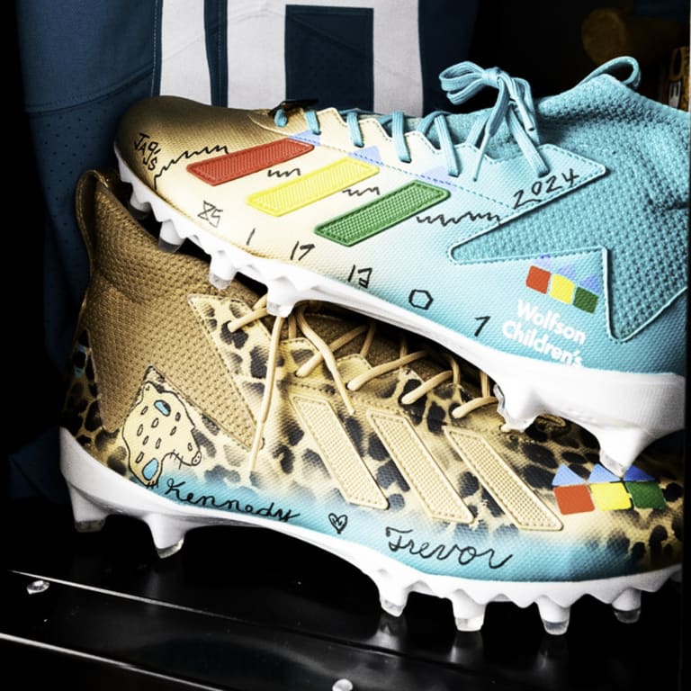 football cleats that have the Wolfson Children's logo on them.