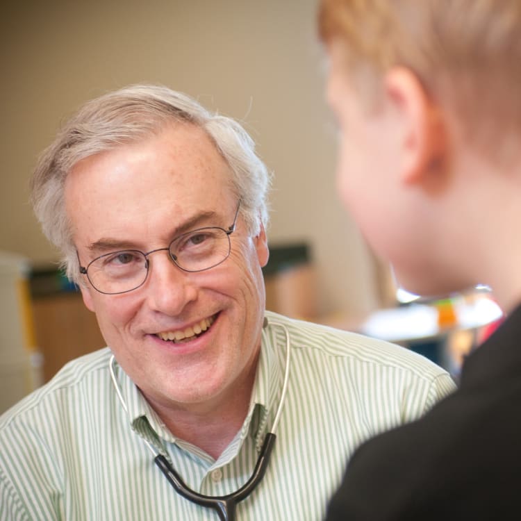 Dr. Joyce talking to a boy patient.