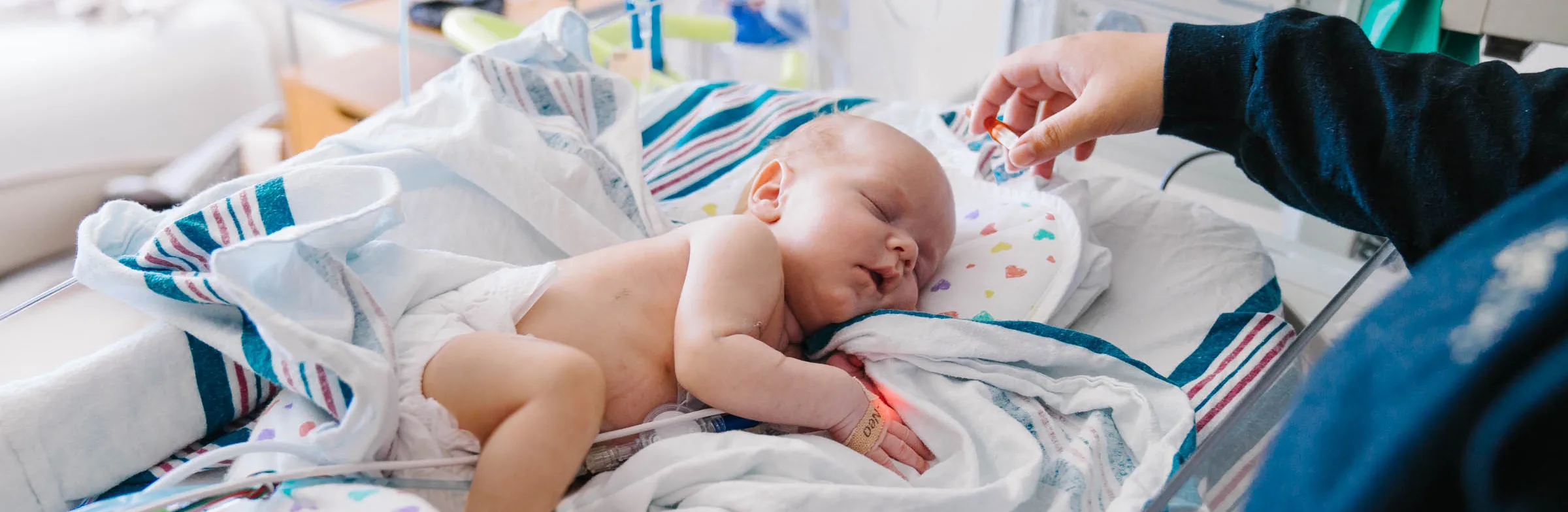 newborn baby sleeping on Wolfson Children's NICU bed