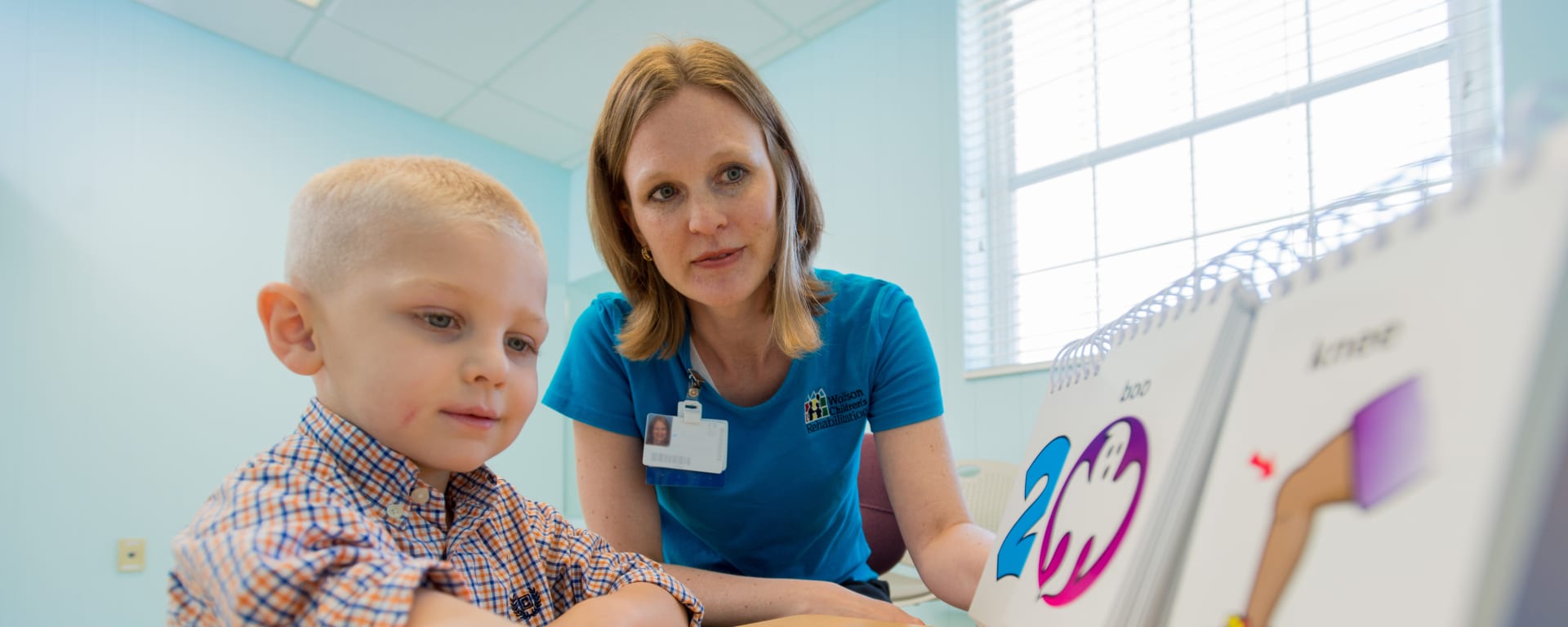 Speech-language pathologist with pediatric patient