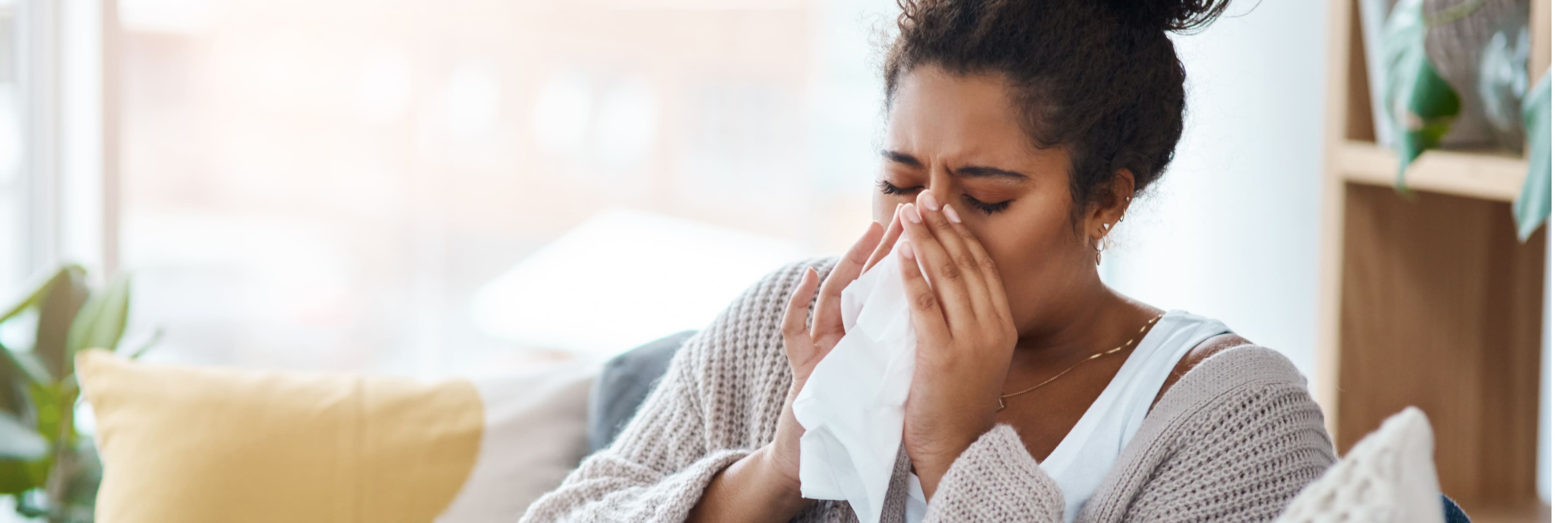 woman blowing nose in tissue