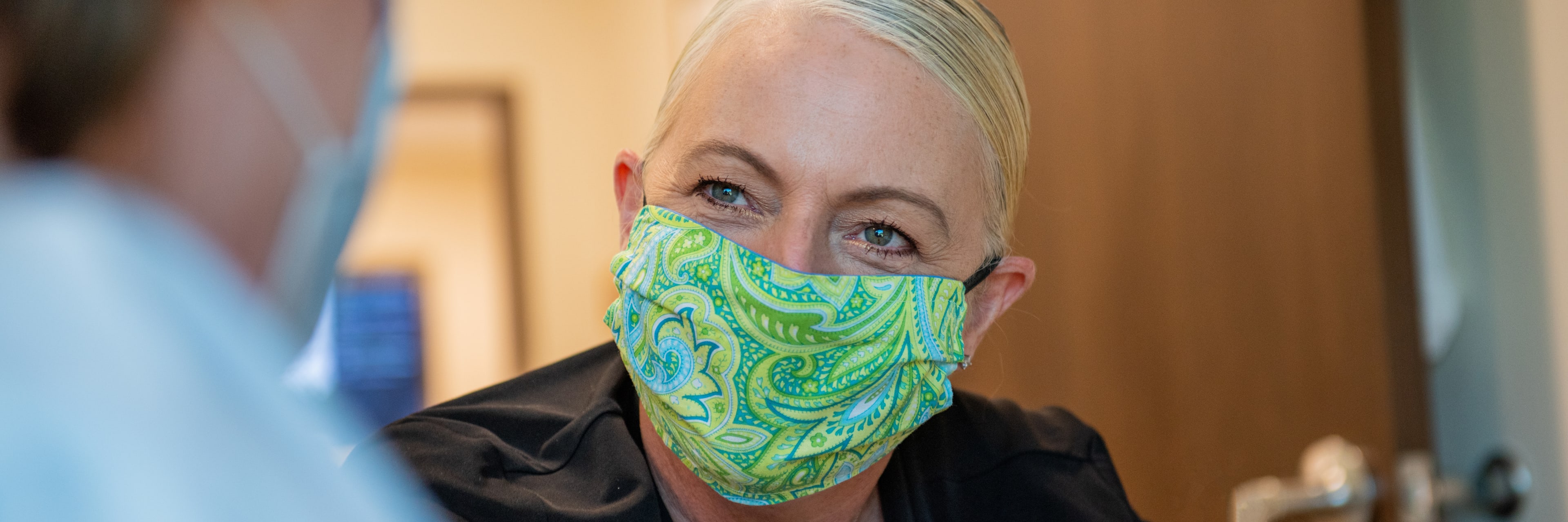 close up of a female nurse wearing a mask