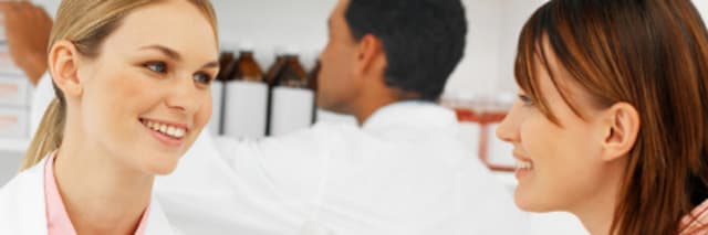 two female pharmacists talking