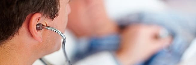 Doctor using a stethoscope to listen to a patient's heartbeat