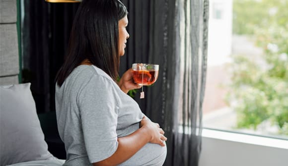 Pregnant woman drinking tea