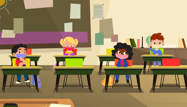 Children wearing face coverings at their desks in the classroom setting