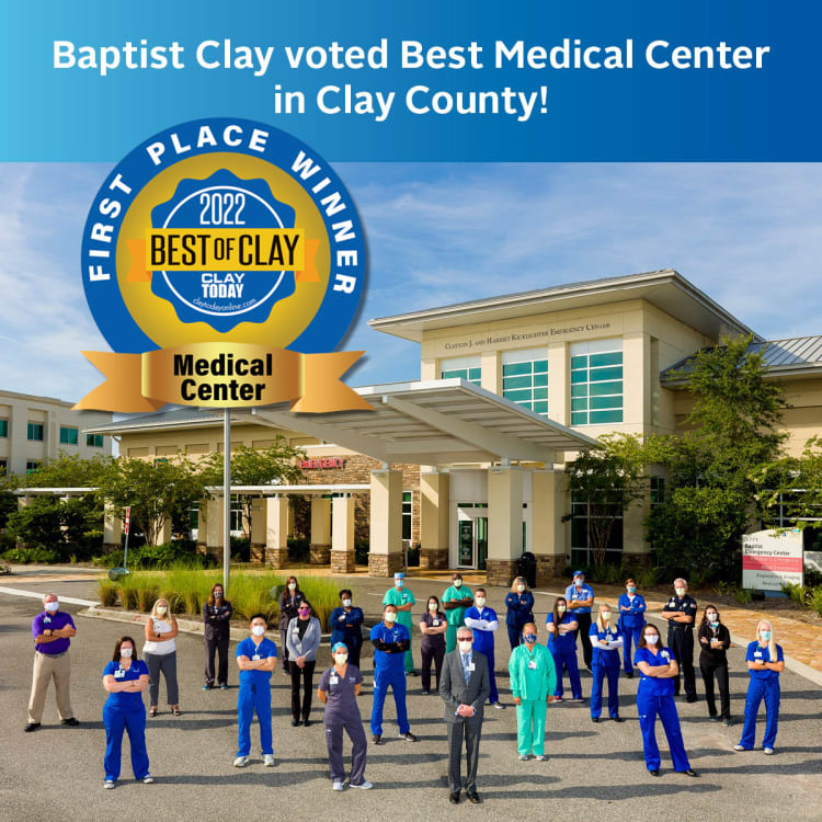 A group of Baptist Health employees standing in front of the Baptist Clay building with text overlay that says "Baptist Clay voted Best Medical Center in Clay County!" and a logo that says "First Place Winner - 2022 Best of Clay - Medical Center"