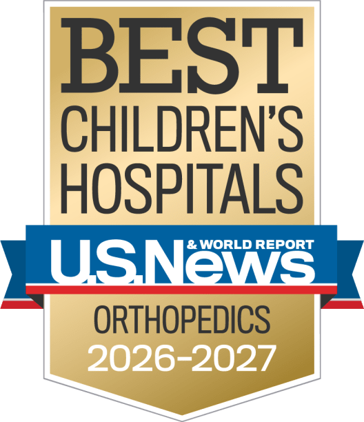 Gold, blue and red colored award badge reading "BEST CHILDREN'S HOSPITALS, U.S. News and World Report, Orthopedics"