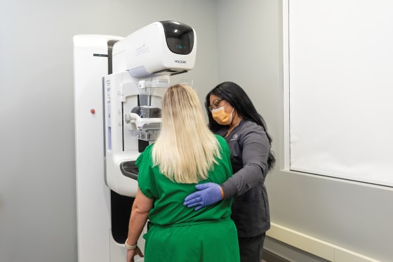 Baptist professional performing mammogram