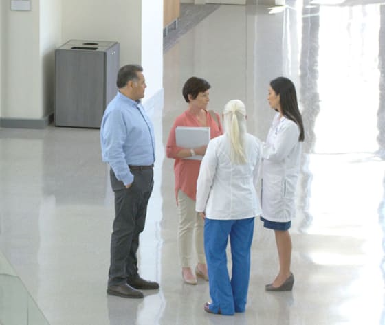 A man and wife talk with two healthcare professionals.