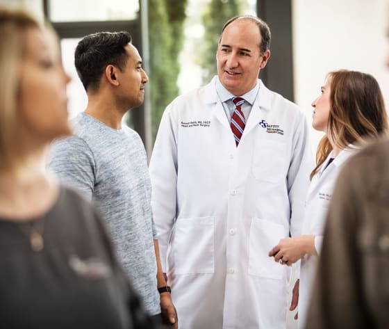 Dr. Russell Smith speaks with a male patient.