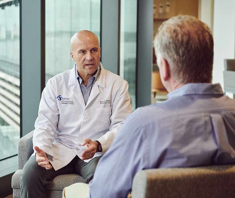 Dr. Gorak, hematologist oncologist, talks with a male patient.