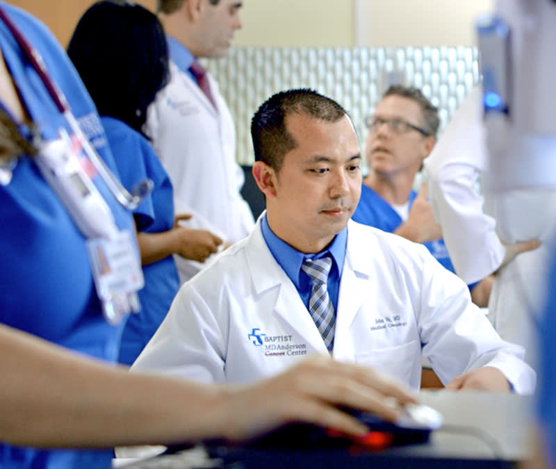A doctor looks through his computer for clinical trials research.