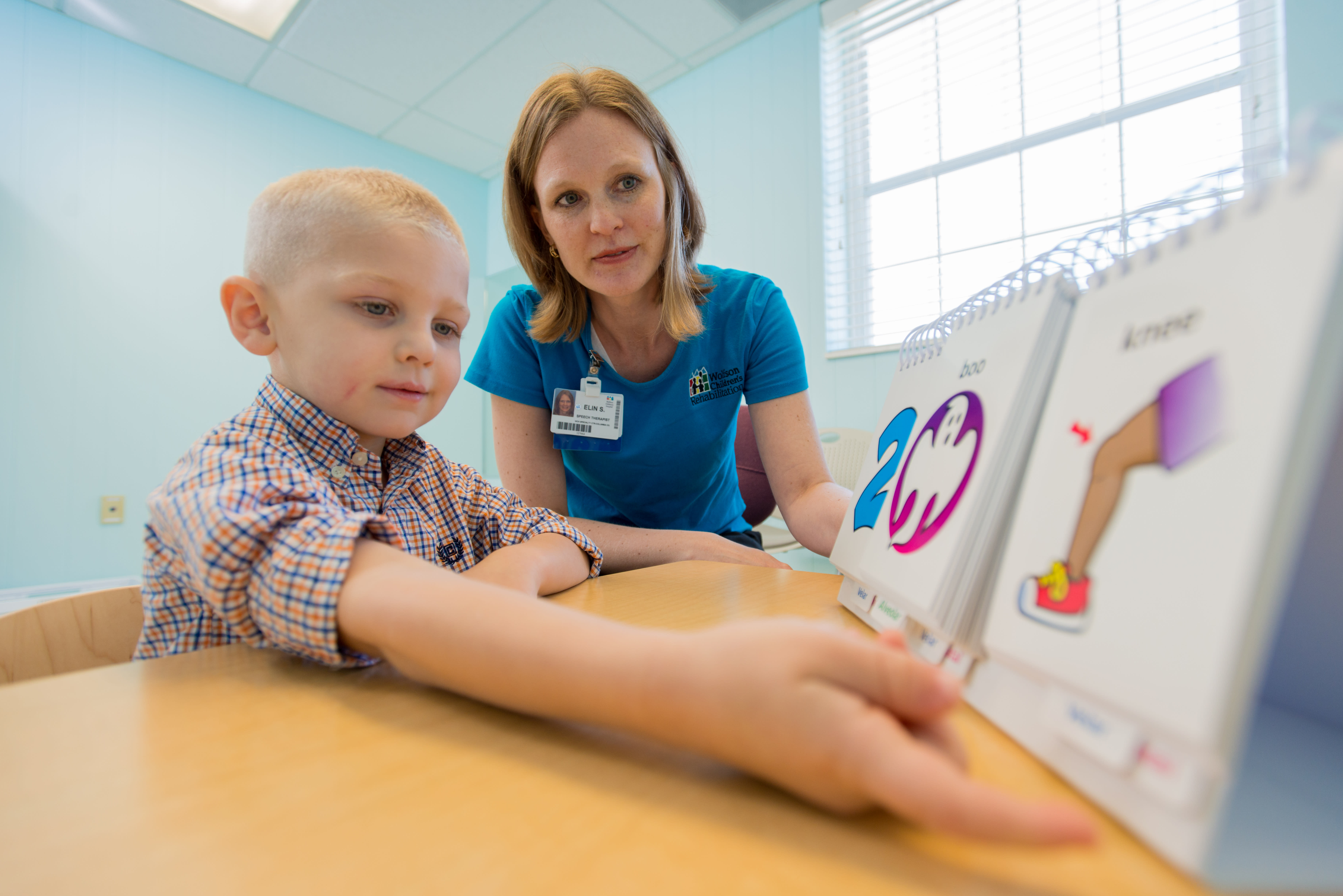 Speech-language pathologist with pediatric patient