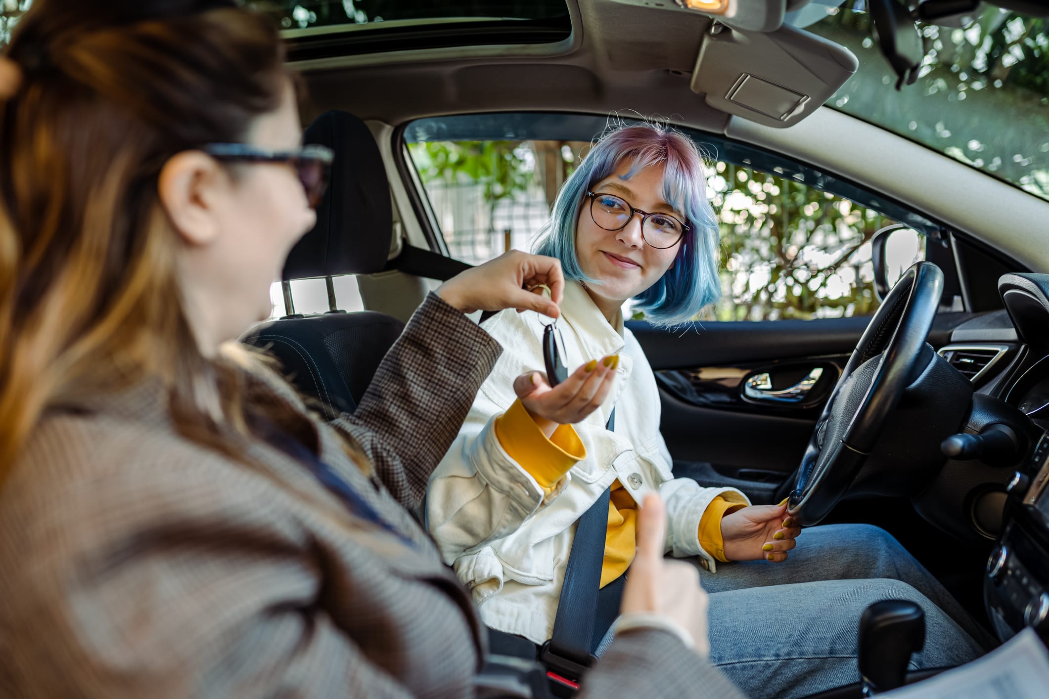 a teen behind the wheel with a parent passenger