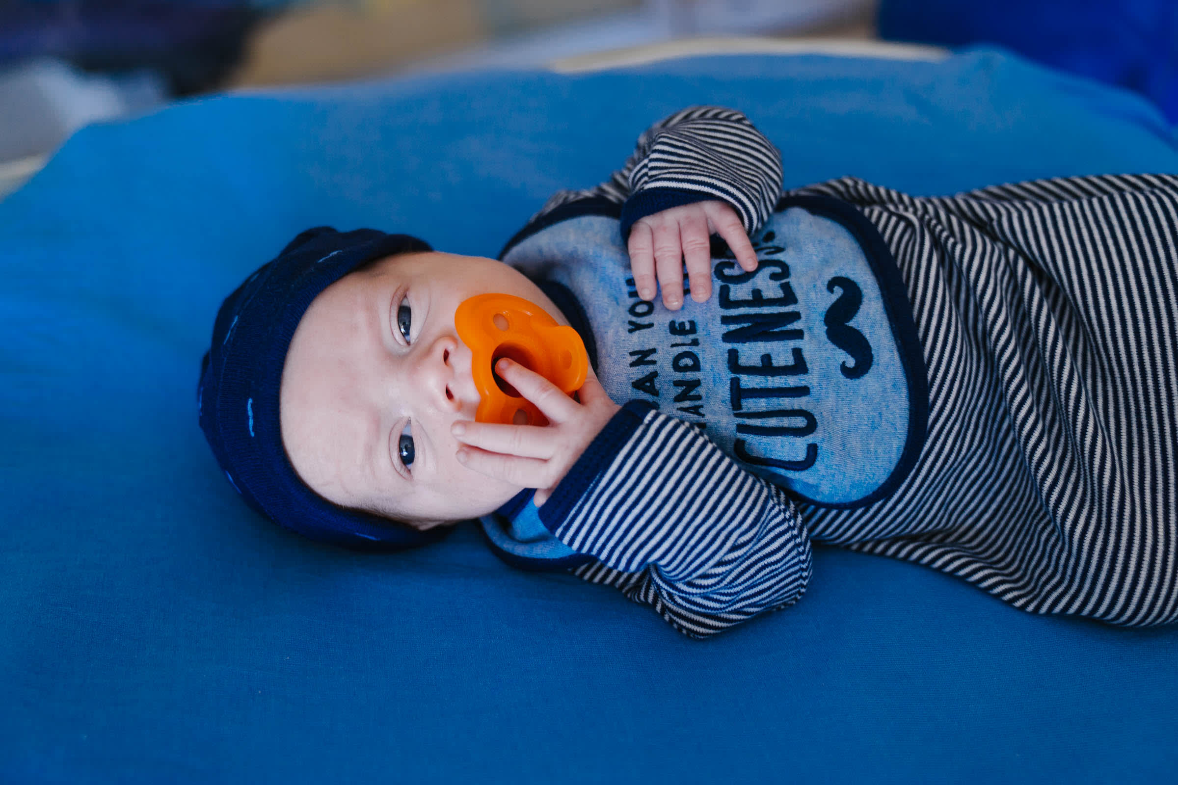 Wolfson Children's infant heart patient looking at camera with pacifier in his mouth