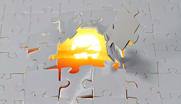 A broken puzzle with an image of the sun behind it