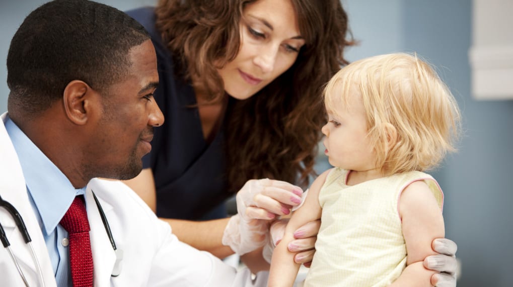 Child receiving vaccination.