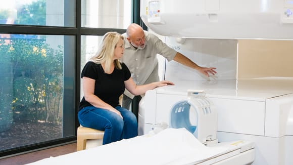 woman and man next to MRI machine