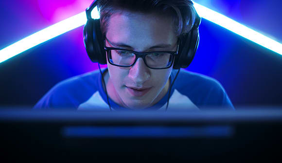 A young man plays video games.