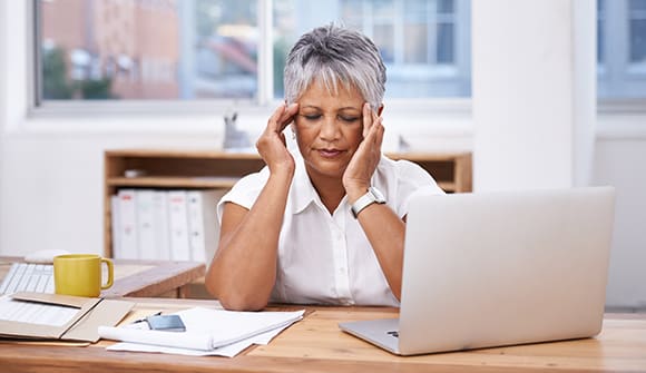 A woman showing symptoms of a brain aneurysm