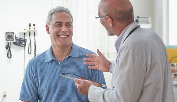 Man with doctor discussing lung cancer screening