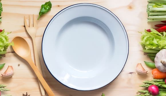 plate, spoon, fork and fresh vegetables