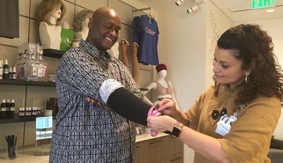 Man getting fitted for medical sleeve