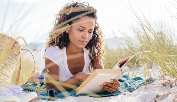 woman reading at the beach