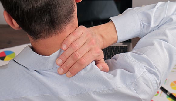 man massaging shoulder