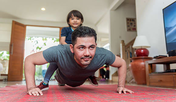 working out at home dad with child