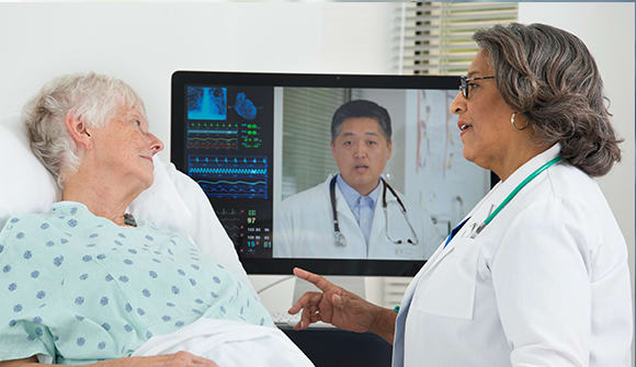 Female hospital patient and her physicians