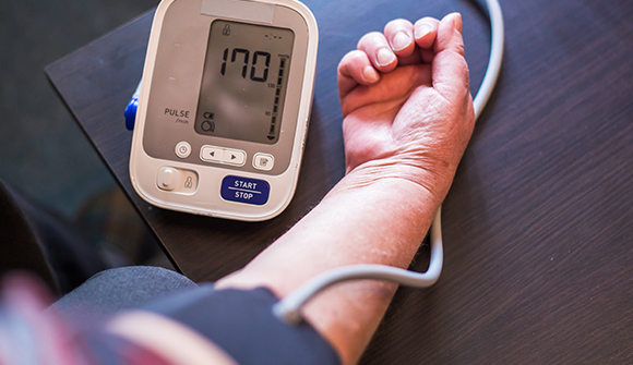 A person using a blood pressure monitor