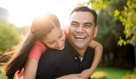 Man carrying daughter on his back