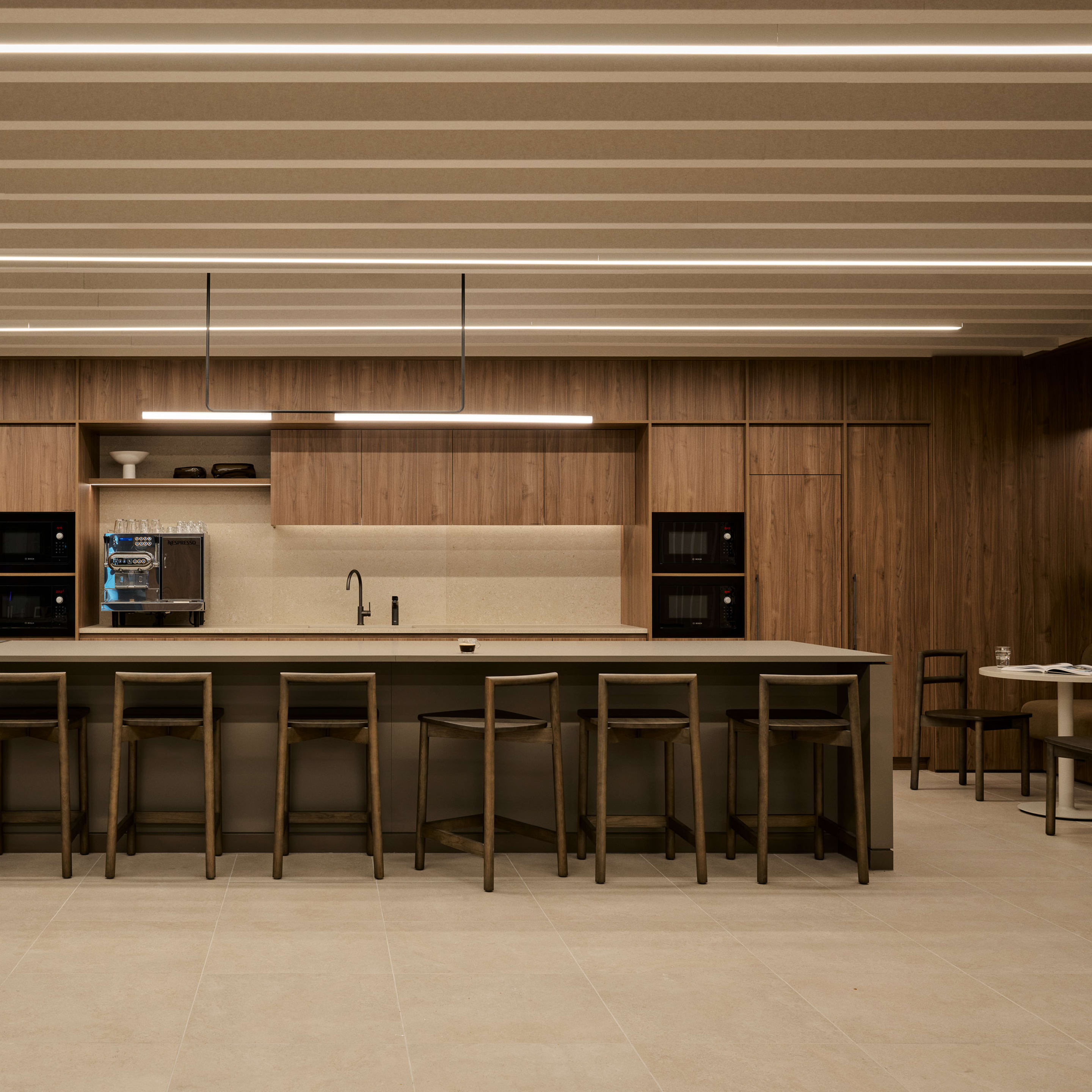Explore the sophisticated design of the Metrics Sydney office break-out area by Geyer Valmont, featuring the acoustic and aesthetic appeal of Zintra Beams Parallel in the ceiling.