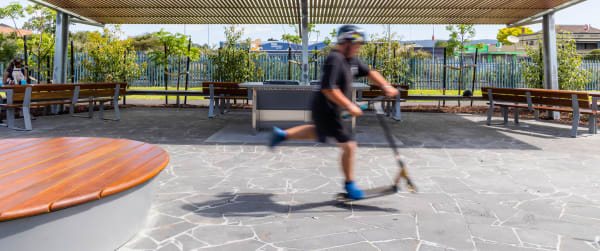 Outdoor recreational area at the Moe Skate Park in Australia, equipped with Botton & Gardiner benches, seating and tables for public use and rest areas