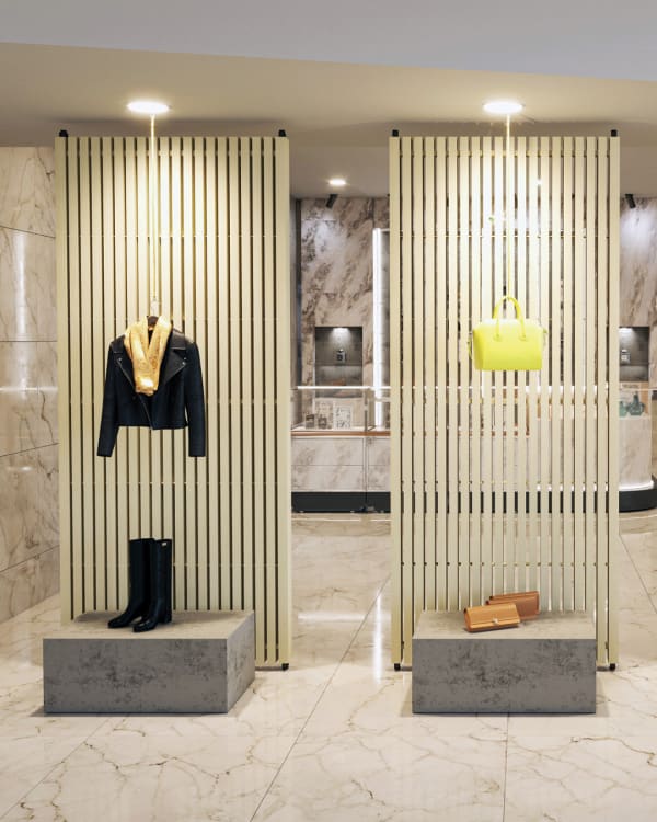 Retail design featuring Zintra double-sided sticks partitions, creating stylish and functional displays for clothing and accessories.