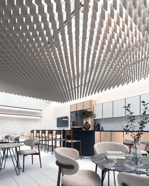 A contemporary open-concept office lounge  space with Zintra Mesh Baffles suspended from the ceiling, enhancing acoustics and adding a striking visual element. The space features modern furniture, a communal kitchen, and a sophisticated, neutral-toned design.