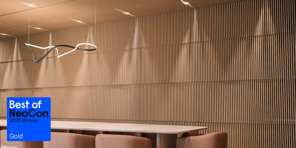 Best of NeoCon 2025 Award-winning Zintra Baffle Systems Stacked featured in a modern interior and showcasing vertical acoustic panels across the walls and ceiling with integrated lighting and minimalist furnishings.