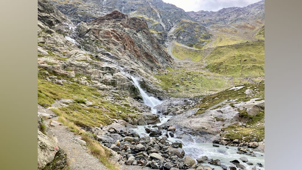 Waterfalls and streams running down the side of a mountain.
