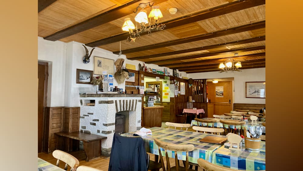 A restaurant with a fireplace and tables set up outside.