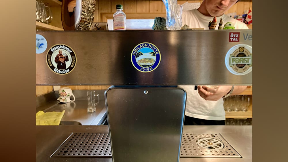 A shot of a glass wall with a large sticker saying "Sinnaun Hotel" on it.