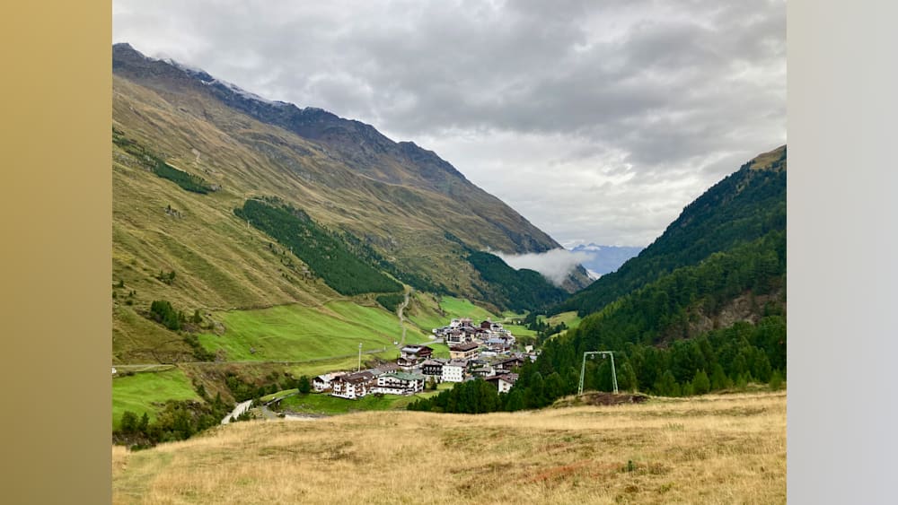 A village with a mountain in the background.